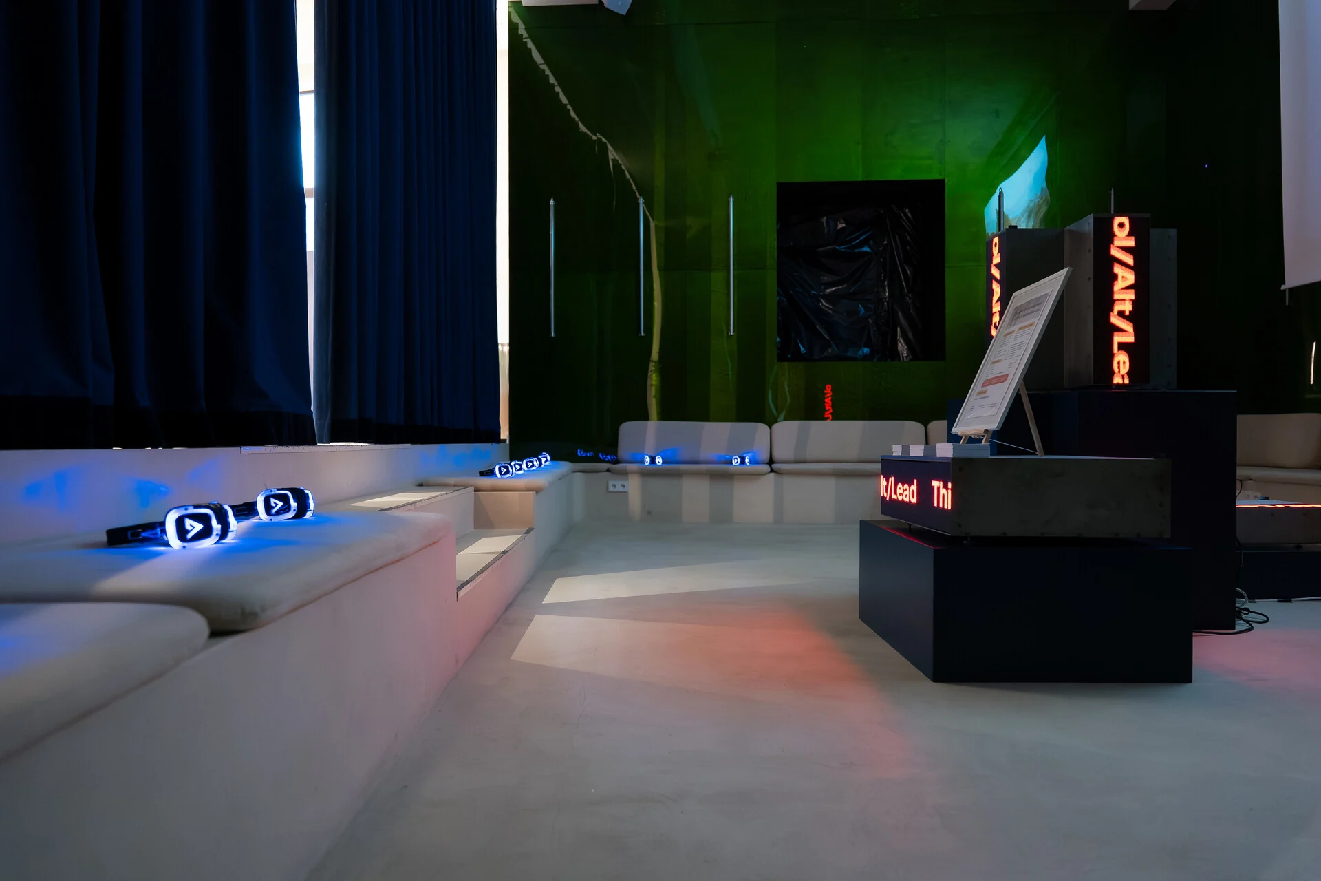 A Bump-built policy experience in a rented venue — lounge seating and branded plinths under coloured light