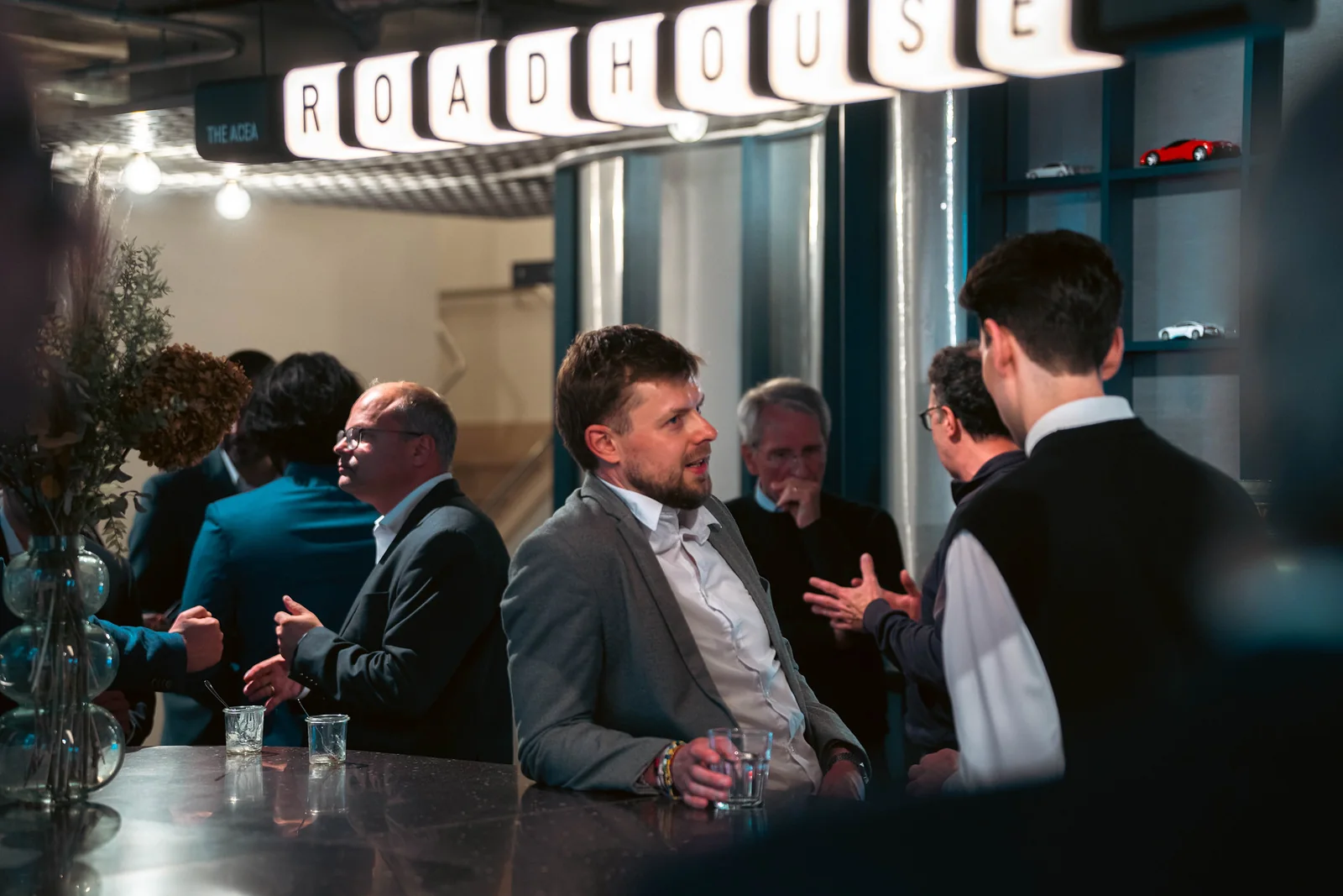 Guests in conversation under the Roadhouse sign
