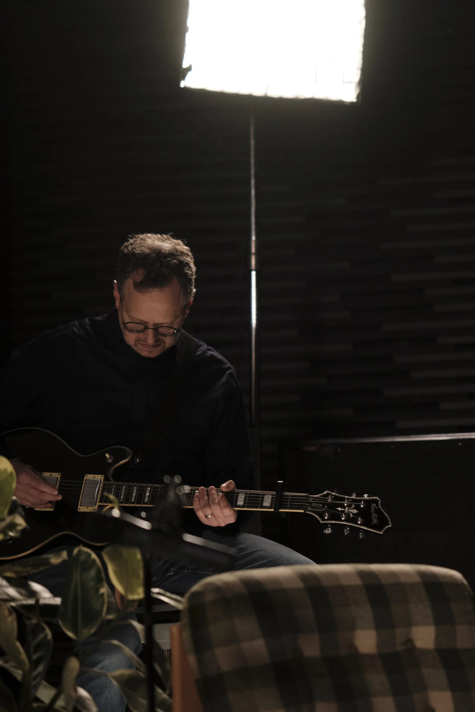 A guitarist playing during the day