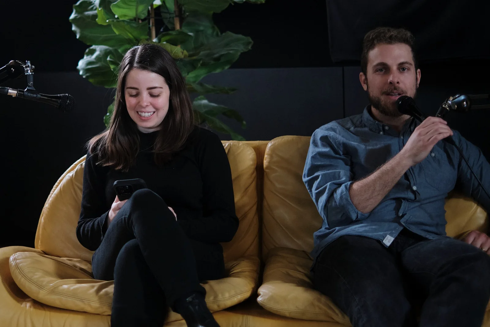 Two guests recording on the yellow sofa