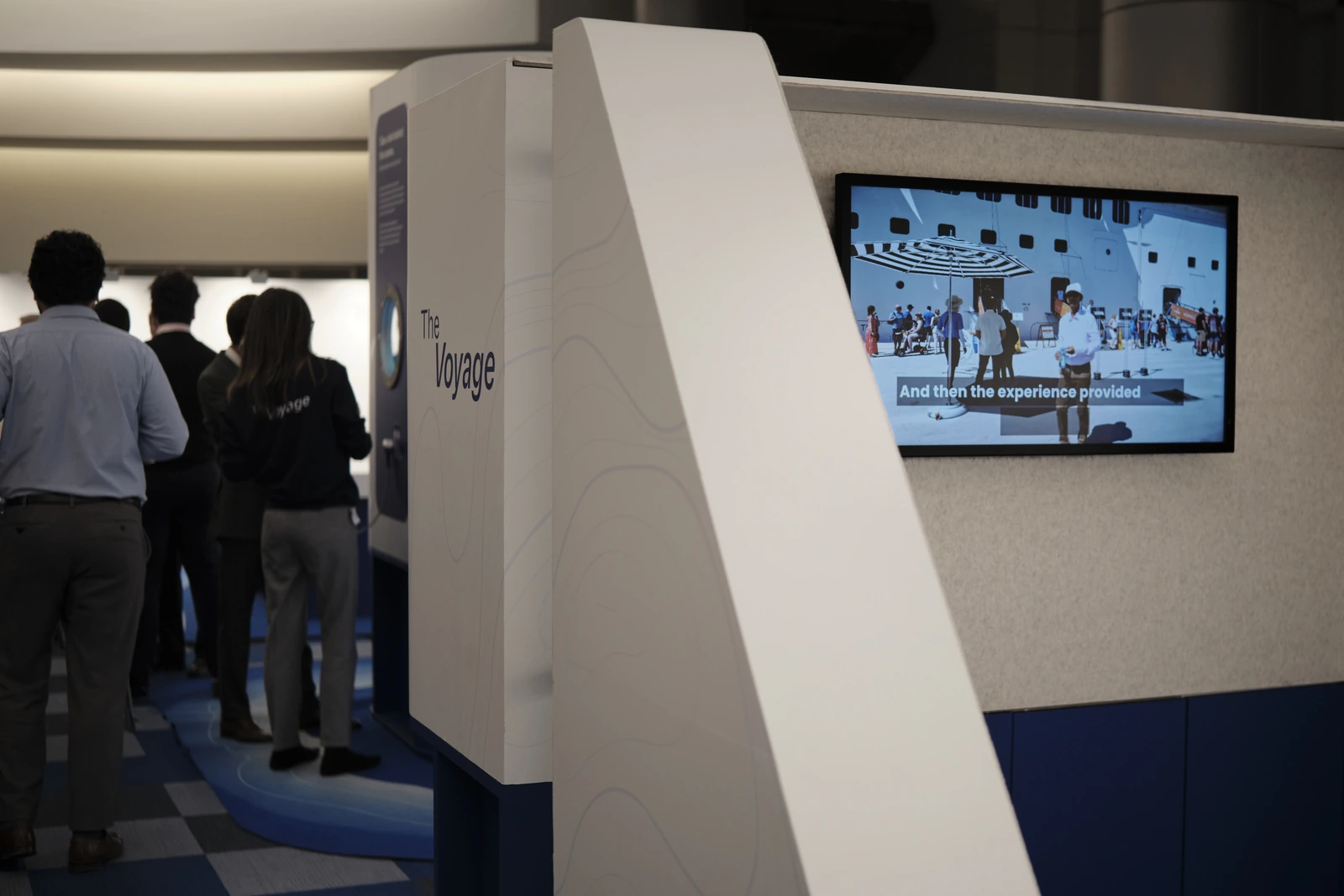 Visitors at the installation, with a wall screen playing the cruise experience film