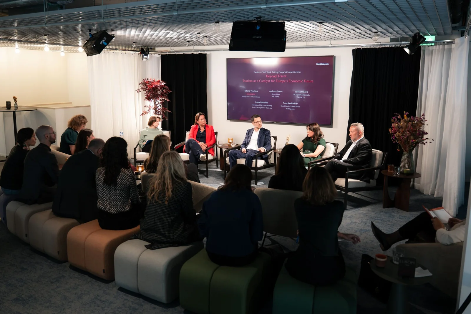 A panel discussion in front of an audience at the Bump Policy Experience Space