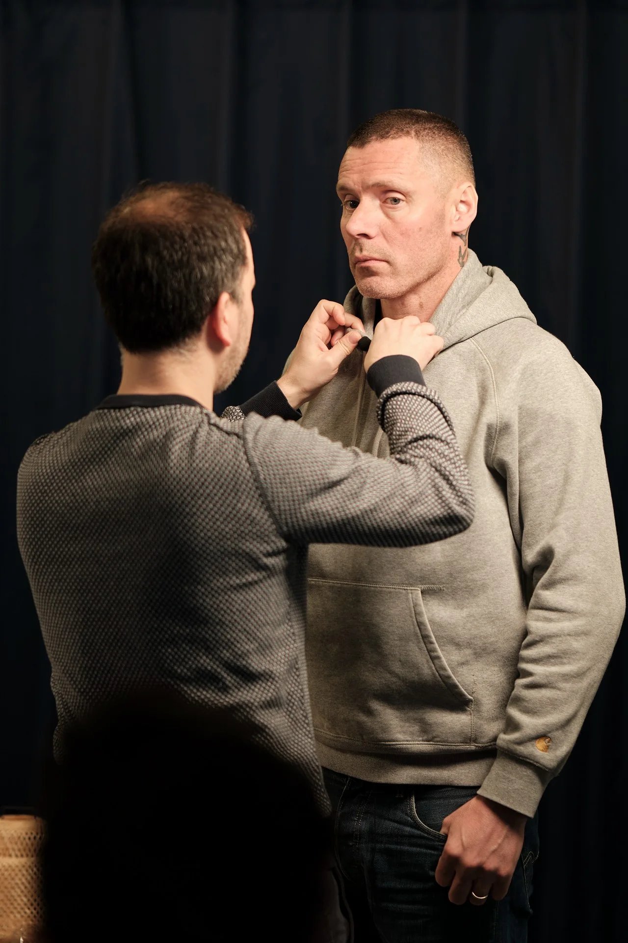 A guest being fitted with a microphone before recording