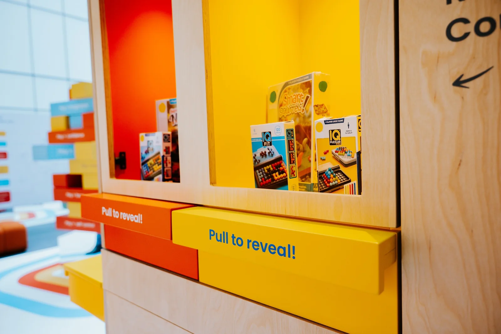 A pull-to-reveal display of toys and packaging